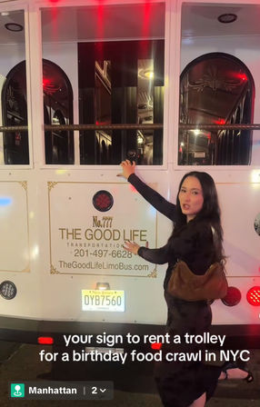 Person posing beside a white party trolley at night in Manhattan, NYC with red accent lights and a caption about renting a trolley for a birthday food crawl.