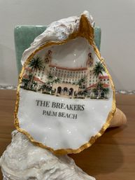 Gold-trimmed souvenir oyster shell with painted Palm Beach resort illustration and palm trees