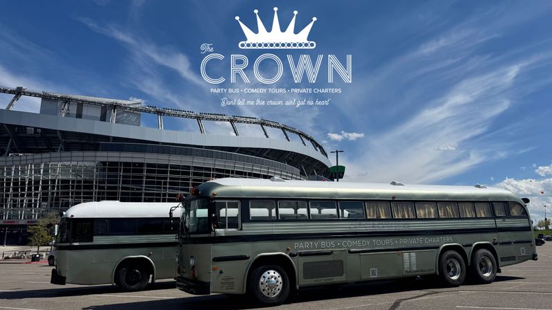 Two vintage green party buses parked in a stadium parking lot beneath a bright blue sky, side view showing retro windows, chrome wheels and lettering for party bus, comedy tours and private charters.
