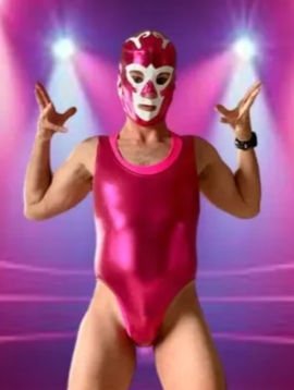 Masked luchador wearing a shiny metallic pink singlet and white-accented pink mask striking a theatrical pose under purple-pink stage spotlights