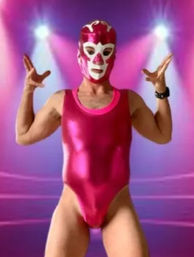 Masked luchador wearing a shiny metallic pink singlet and white-accented pink mask striking a theatrical pose under purple-pink stage spotlights