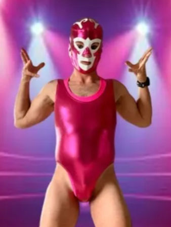 Masked luchador wearing a shiny metallic pink singlet and white-accented pink mask striking a theatrical pose under purple-pink stage spotlights