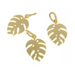 Three shiny gold Monstera leaf pendant charms for tropical boho jewelry on a white background