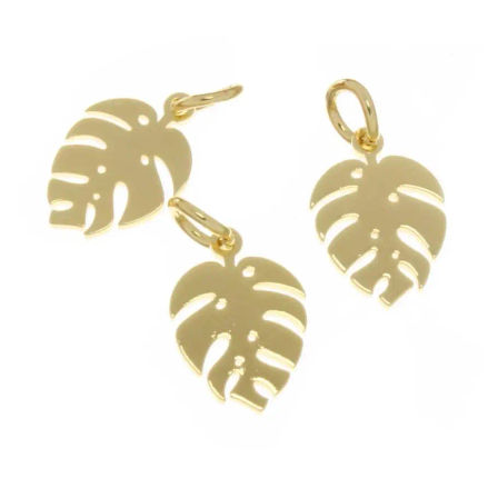 Three shiny gold Monstera leaf pendant charms for tropical boho jewelry on a white background