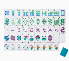 Playful pastel floral mahjong tile set arranged in rows on a white background — white tiles decorated with teal, blue and purple circle, bamboo and character suits, flower tiles, 'NEWS' letter tiles, jokers, and a single teal scoring tile.