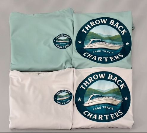 Folded mint and white T-shirts with matching circular boat-charter logos showing a motorboat on Lake Travis with hills and water in the background