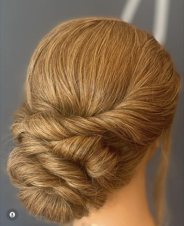 Polished golden-blonde twisted low bun — elegant chignon updo perfect for bridal, wedding, and formal hairstyles