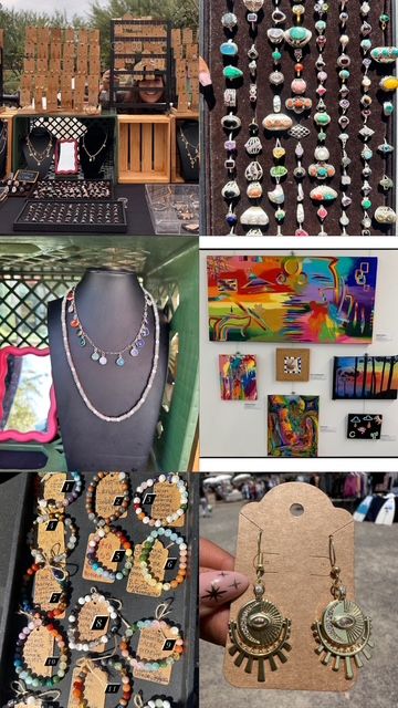 Outdoor artisan market stall displaying handmade jewelry—rows of rings, pendant necklaces, beaded bracelets and brass sunburst earrings—beside colorful abstract paintings at a craft fair.