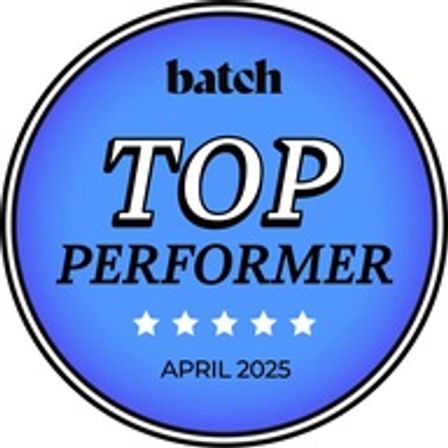 Shiny blue circular award badge that reads TOP PERFORMER with five white stars and the date April 2025.