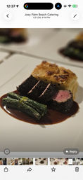 Fine-dining plate with herb-crusted beef medallions sliced to a pink center, square potato gratin, tied green bean bundle and glossy red wine reduction.