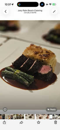 Fine-dining plate with herb-crusted beef medallions sliced to a pink center, square potato gratin, tied green bean bundle and glossy red wine reduction.