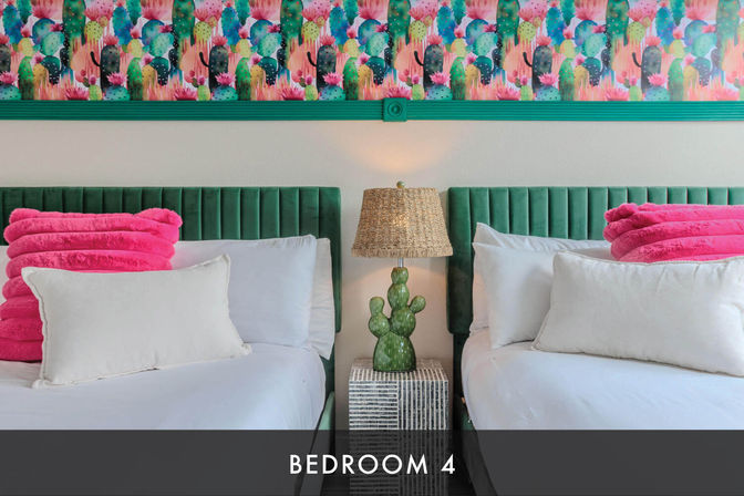 Vibrant twin bedroom with green velvet headboards, white bedding and large white pillows, hot-pink folded throw blankets, cactus-shaped bedside lamp on a mirrored nightstand, and colorful cactus-print wallpaper above — captioned "BEDROOM 4".