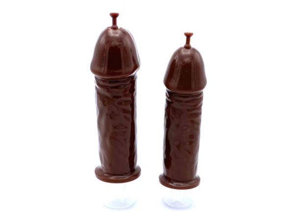 Two dark chocolate novelty lollipops shaped like penises on a clean white background, playful adult party favors