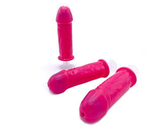 Three bright pink novelty silicone penis-shaped ice-pop molds with clear suction bases on a white background — playful bachelorette or party accessory.