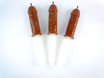 Three brown penis-shaped popsicle molds with white handles on a plain white background — playful adult party novelty