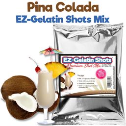 Pina Colada gelatin shot mix in a shiny silver pouch with a creamy piña colada shot in a plastic stemmed cup, garnished with pineapple wedge, cherry and a mini umbrella, alongside halved coconuts — tropical dessert shot mix.