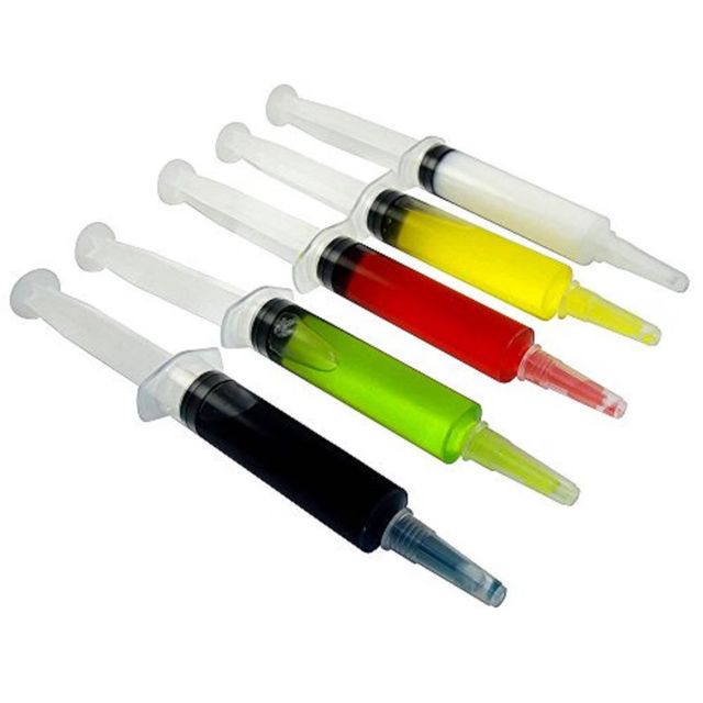 Five plastic novelty syringes filled with bright liquids—black, neon green, red, yellow, and clear—arranged diagonally on a white background, perfect for party favors or crafts.