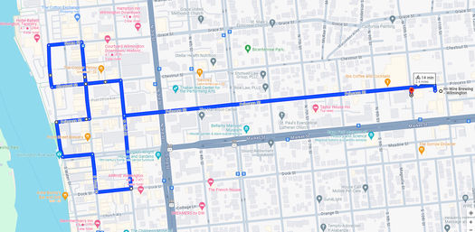 Blue bike route map of downtown Wilmington, NC — looping along Cape Fear riverfront streets then heading east on Princess Street across historic downtown, about 2.4 miles (≈14 min).