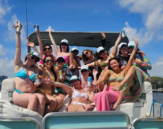 Group of friends in colorful bikinis and caps enjoying a sunny pontoon boat party, waving and holding canned drinks on blue coastal water