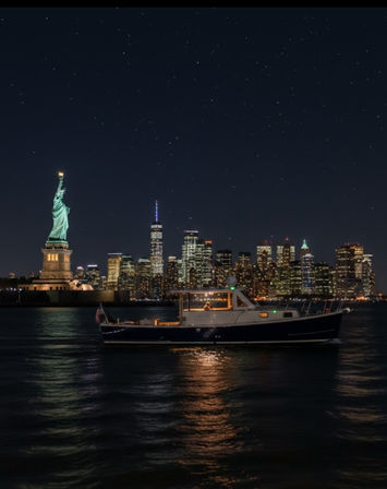Statue of Liberty and Manhattan skyline at night with a lit boat on the Hudson River and shimmering city light reflections under a starry sky.