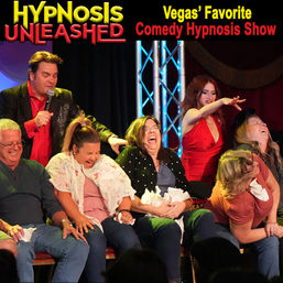 Las Vegas comedy hypnosis show on a live stage with a male hypnotist holding a microphone and a female assistant guiding laughing volunteer participants clutching tissues and reacting