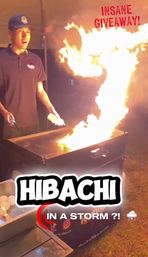 Nighttime outdoor hibachi chef igniting a giant flame on a flat-top griddle at a street-food event, eggs and cooking tools visible with playful "Insane Giveaway" text overlay.