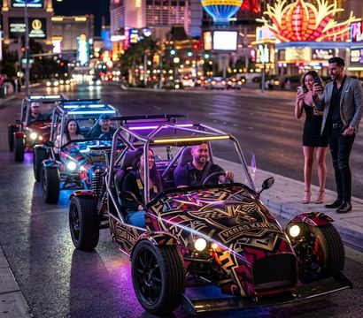 Neon-lit open-frame buggies cruising the Las Vegas Strip at night with bright casino lights and onlookers snapping photos