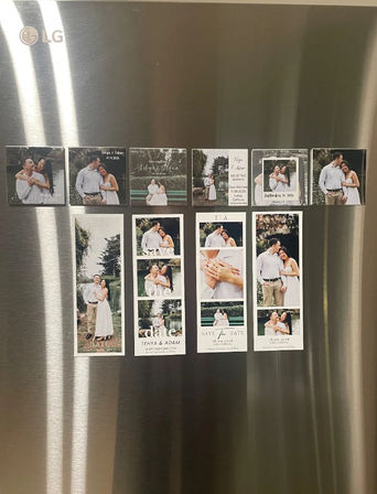 Stainless-steel fridge door in a kitchen with neatly arranged wedding save-the-date photo magnets and vertical engagement photo strips