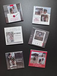 Flat-lay of six Valentine's-themed photo tiles on a dark tabletop featuring a couple's beach photos and romantic captions like "Happy Valentines" and "My Forever Valentine" — stylish Valentine's Day gift idea.
