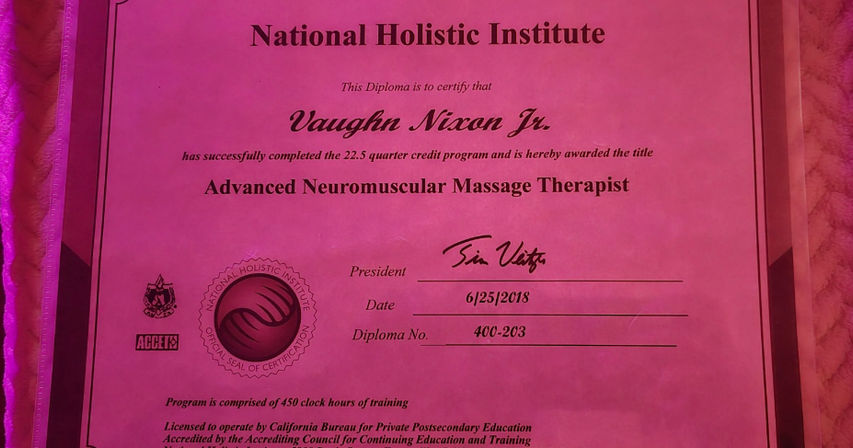 Bright pink diploma-style certificate awarding the title Advanced Neuromuscular Massage Therapist, showing an embossed seal, signature and date (6/25/2018) on a textured fabric background — massage therapist certificate photo.