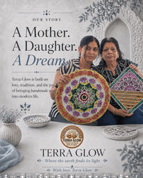Mother and daughter artisans in a bright studio holding colorful handmade mandala and geometric wall art pieces, styled with decorative bowls and carved Indian-inspired backdrop — artisan home decor.