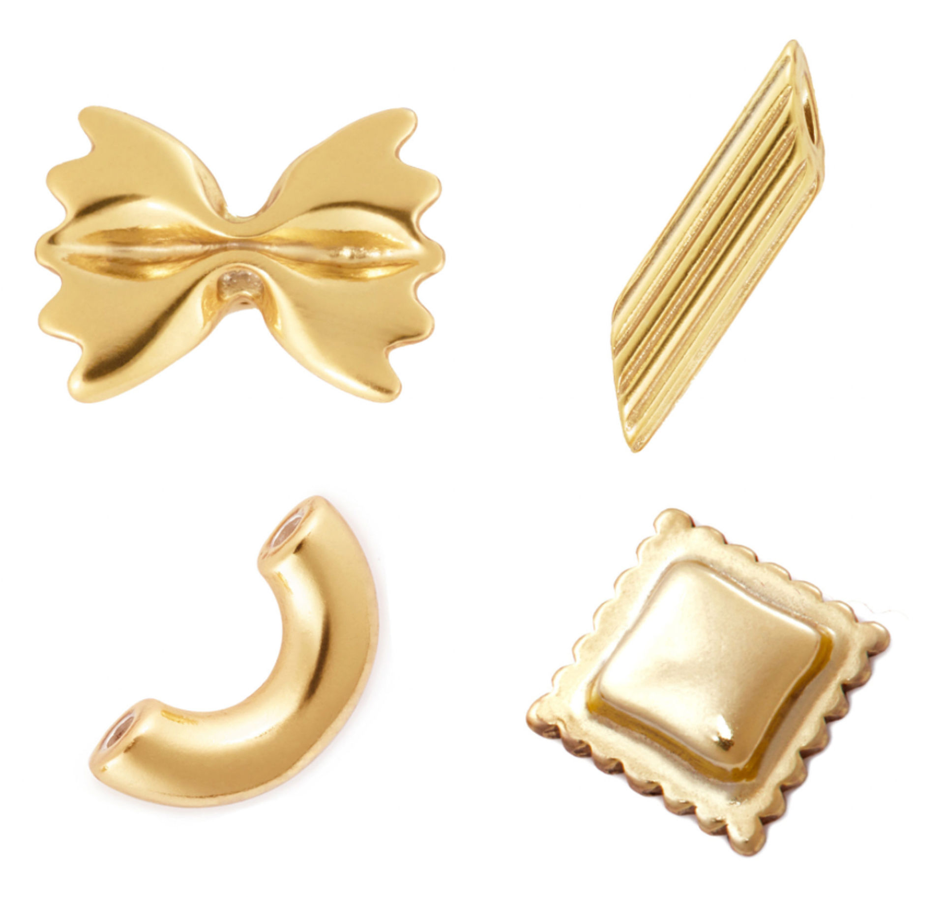 Four gold-tone pasta-shaped beads — farfalle bow-tie, ridged penne, curved elbow macaroni, and square ravioli — photographed on white background
