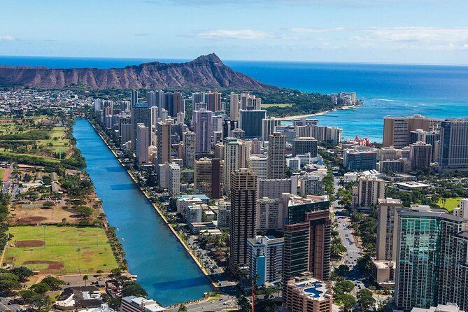 Aerial view of Honolulu skyline with the blue Ala Wai Canal, Waikiki high-rises, Diamond Head crater and turquoise Pacific Ocean