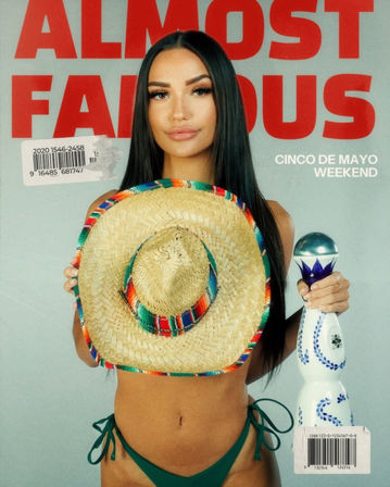 Magazine-style cover showing a model in green bikini bottoms holding a colorful straw sombrero over her chest and a blue-and-white decorative bottle, long dark hair, with bold red 'ALMOST FAMOUS' title and 'Cinco de Mayo Weekend' text on a gray background.