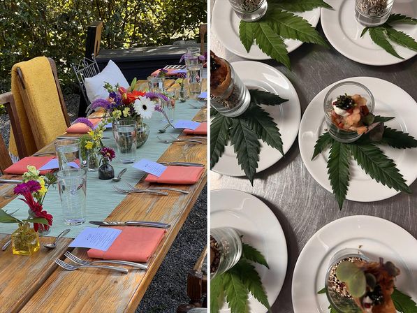 Outdoor garden dining setup on a rustic wooden table with coral napkins, glassware and colorful flower arrangements; plated appetizer shots on white plates accented with large serrated green leaves.