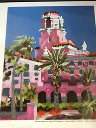 Bright painting of a pink Mediterranean‑revival hotel with terracotta domes, arched walkways and swaying palm trees under a clear blue St. Petersburg, Florida sky.
