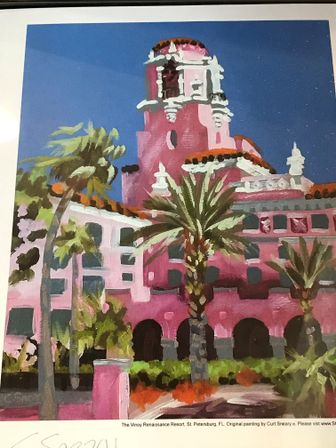 Bright painting of a pink Mediterranean‑revival hotel with terracotta domes, arched walkways and swaying palm trees under a clear blue St. Petersburg, Florida sky.