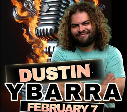 Promotional stand-up comedy poster with a smiling bearded man with long curly hair and crossed arms in front of a flaming vintage microphone, bold headline name text and event date February 7.