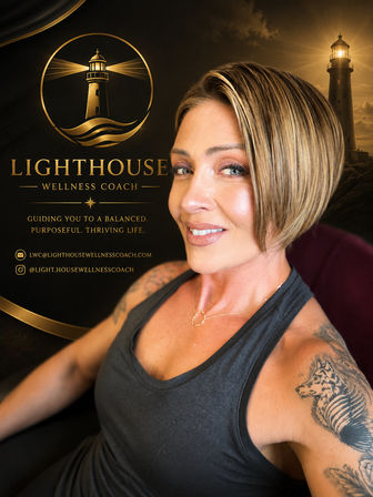 Smiling female wellness coach headshot with short blonde bob and wolf shoulder tattoo, posed against black-and-gold lighthouse branding and a glowing coastal lighthouse backdrop — elegant wellness logo and contact icons visible.