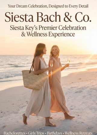 Two women in flowing dresses walk barefoot along a Siesta Key beach at sunset, smiling and holding champagne glasses for a relaxed bachelorette or girls-trip celebration.