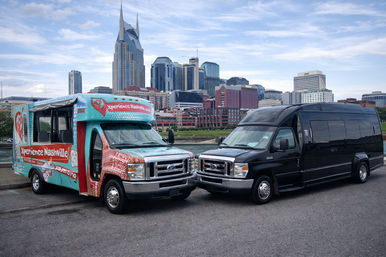 Bright turquoise open-sided tour shuttle and black passenger van parked by the river with downtown Nashville skyline and the twin-spired AT&T “Batman” building under a blue sky, ready for city tours.