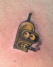 Close-up of a small yellow Bender (Futurama) robot tattoo grinning and smoking a lit cigar on skin