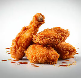 Close-up of crispy golden fried chicken — one drumstick and three breaded pieces with spicy sauce drips on a white background