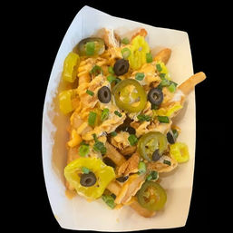 Cheesy loaded fries in a paper tray topped with sliced jalapeños, banana pepper rings, black olives, green onions and shredded chicken