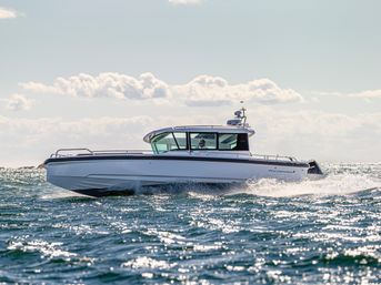 White cabin motorboat cruising across sunlit coastal waters with sparkling blue waves and fluffy clouds overhead