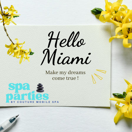 Textured card reading "Hello Miami — Make my dreams come true!" surrounded by yellow blossoms, a pen and spa-themed stones — bright tropical greeting.