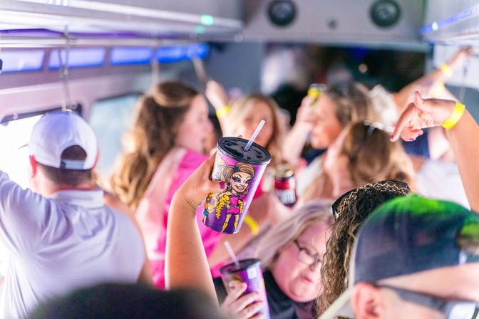 Lively party bus interior with a crowded group raising colorful illustrated cups and cans, neon lighting and wristbands as friends dance and cheer.