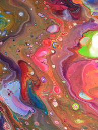 Vibrant abstract fluid painting close-up with swirling neon pinks, greens, blues and earthy browns forming marbled cells and glossy droplets