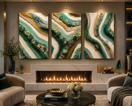 Modern luxury living room with a lit linear fireplace in a marble mantel, three-panel teal and gold geode abstract triptych above the hearth, beige sofas, black marble coffee table with white flowers, and decorative geode accents under warm ambient lighting.