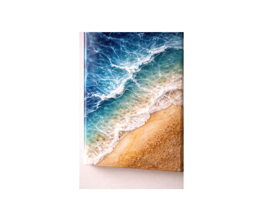 Aerial-style canvas artwork of turquoise ocean waves crashing onto a golden sandy beach with textured, foamy resin wave details.